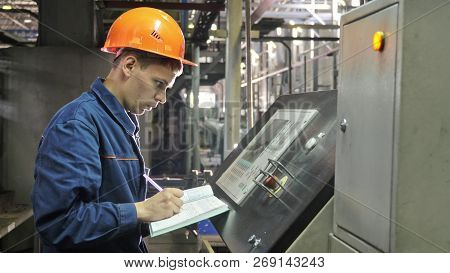Russia, Angarsk - June 8, 2018: Operator Monitors Control Panel Of Production Line. Manufacture Of P