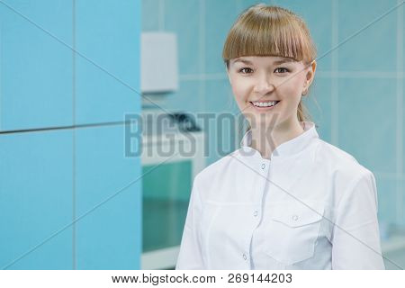 Smiling Female Dentist Assistent At The Reception In Modern Dental Clinic Office
