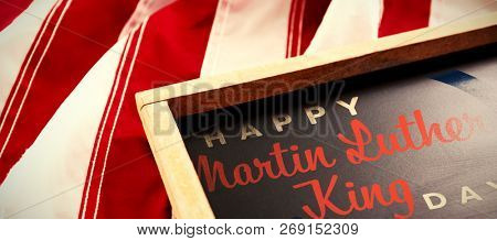 happy Martin Luther King day against american flag and slate