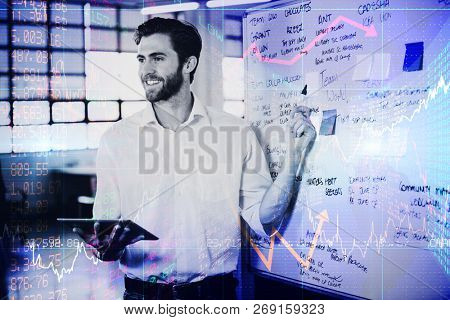 Stocks and shares against smiling businessman explainging strategies on whiteboard
