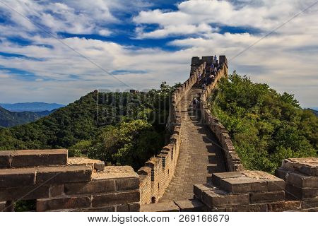 Tourists Walking On The Great Wall Of China, In The Mutianyu Village, One Of Remote Parts Of The Gre