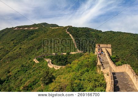 Tourists Walking On The Great Wall Of China, In The Mutianyu Village, One Of Remote Parts Of The Gre