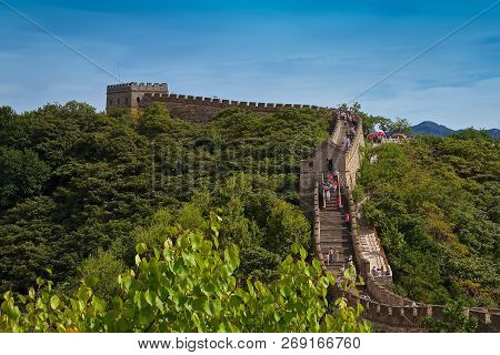 Tourists Walking On The Great Wall Of China, In The Mutianyu Village, One Of Remote Parts Of The Gre
