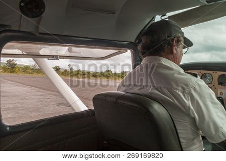 Canaima, Venezuela - August 18, 2015: Pilot Of A Small Cessna 300 Adf Airplane At The Airport Of Can