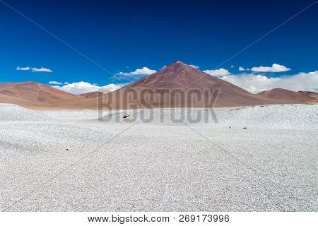 Borax Deposits At Laguna Colorada Lake With Mountain Peaks In The Background, Bolivia