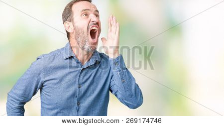 Handsome middle age elegant senior man over isolated background shouting and screaming loud to side with hand on mouth. Communication concept.