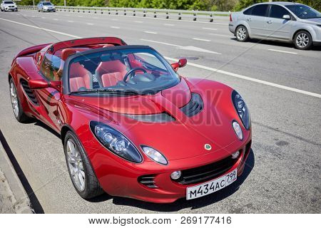 MOSCOW, RUSSIA - MAY 27, 2018: Red Lotus car stands on multilane highway.