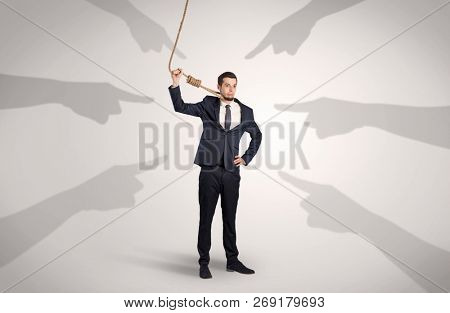 Young businessman trying to suicide with pointing hands concept