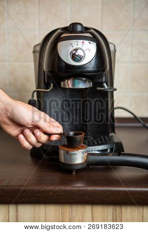 Photo Of Coffee Maker, Human Hand Pouring Coffee Into Mug In Kitchen