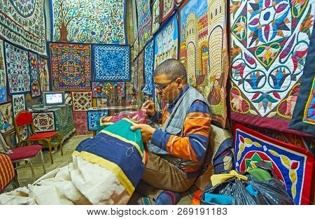 Cairo, Egypt - December 21, 2017:  The Artisan Makes The Applique Of The Cover, Sitting In His Works