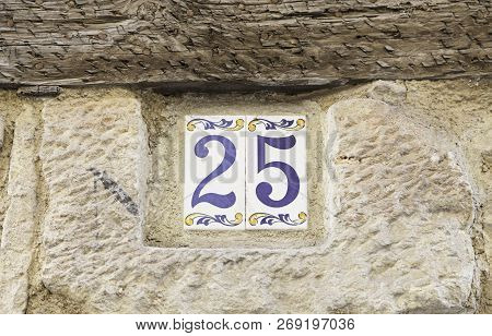 Number Twentyfive On A Wall, Detail Of A Number Of Information On A Wall In The City