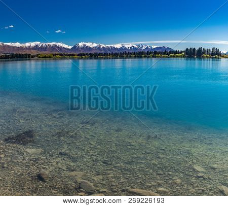 Lake Ruataniwha, New Zealand, South Island, trees and mountains, water reflections