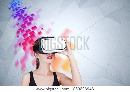 Young Woman Wearing Black Tank Top And Vr Glasses Sitting Near Geometric Pattern Wall With With Red 