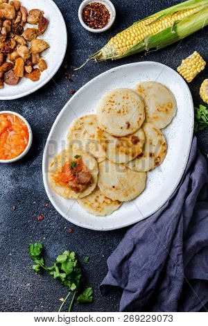 Colombian Food. Maize Arepas And Fried Pork Chicharron Ans Colombian Tomato Sauce. Top View. Black B
