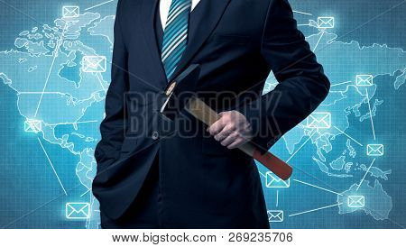 Businessman holding tool with global map graphic on the background