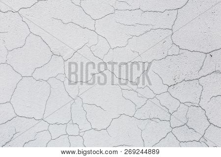 Texture Of White Dirty Cracked Wall. Small Straight Cracks. Direct Fracture On Painted Surface. Cell