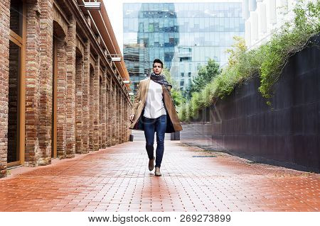 Young Man Wearing Winter Clothes In The Street.