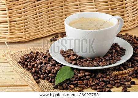 cup with coffee and coffee beans