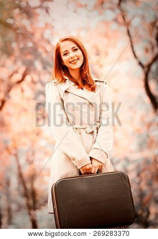 Style Redhead Girl With Suitcase On Autumn Season Park. Image With Filter