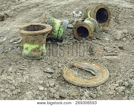 Old Sewer Manhole Covered In Soil On Building Side.  Sewer Cover On The Road In The City.