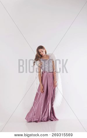 Girl In Pink Dress With Angel Wings On White Background. Angel-woman