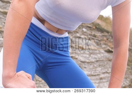 Flat Belly Girl During Diaphragmatic Breathing Exercises Bodyflex On The Rock Background. Belly Clos