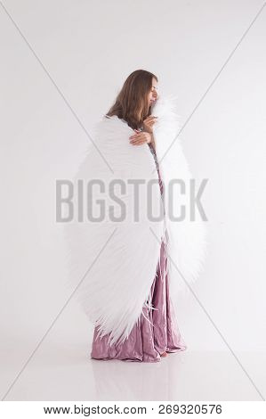 Girl In Pink Dress With Angel Wings On White Background. Angel-woman