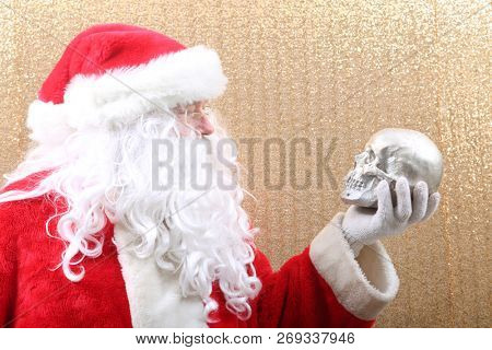 Santa Claus. Santa Claus holds a Human Skull. Santa finds an old Elf Skull. Old Man Winter is scared. Sold my soul to Santa. 