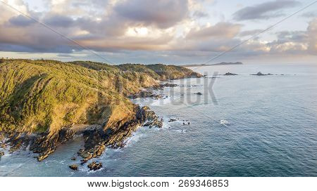 Bay Beach Cliffs And Forest At Sunrise Aerial Photo