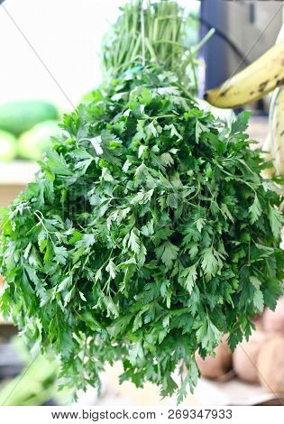 A Bunch Of Fresh Parsley Hanging In A Market