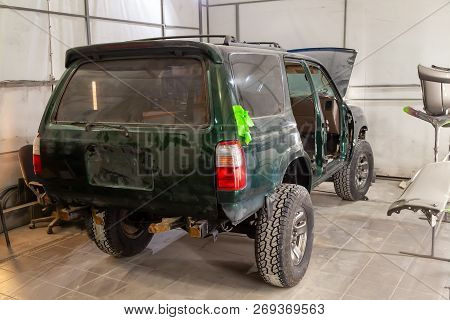 The Green Car After A Serious Accident With A Completely Broken Front Of The Body Without An Engine 