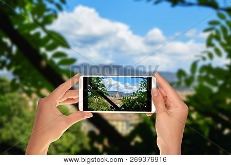 A Tourist Is Taking A Photo Of Duomo Santa Maria Del Fiore From One Public Park. Florence, Italy On 