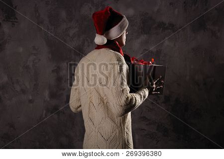 Christmas Gift Concept. Man In Santa Hat Bring Gift For You. Attractive Man Hold Box.  Christmas And
