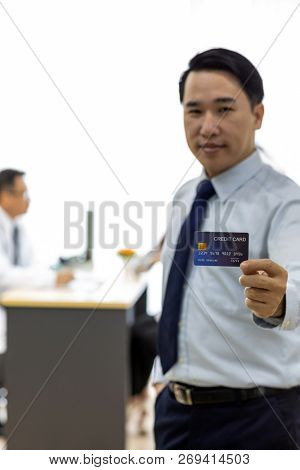 Portrait of Young adult Patient with credit card with examination room medical office background for insurance concept