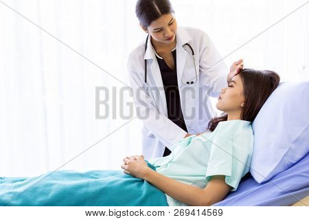 Asian Doctor make routine health check with patient in hospital ward