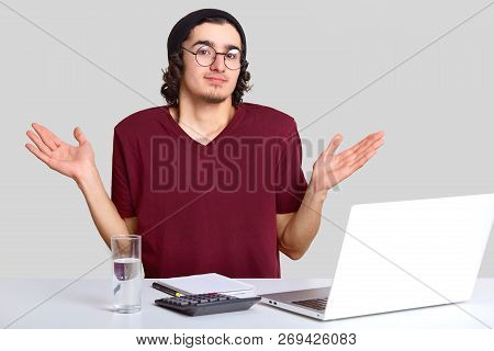 Hesitant Financier Shruggs Shouldres, Cant Find Correct Figure, Sits At Desktop With Calculator, Wor