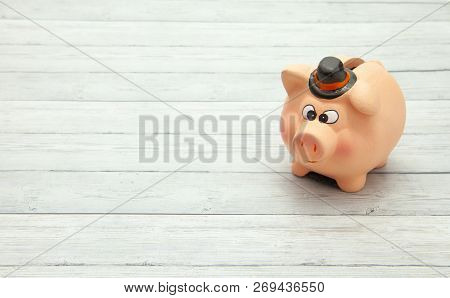 Ceramic Pink Piggy Bank On Wooden Background, Space For Text