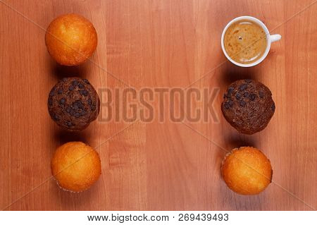 White Porcelain Cup Of Coffee And Tasty Chololate And Vanilla Muffins, On Wooden Table With Copy Spa