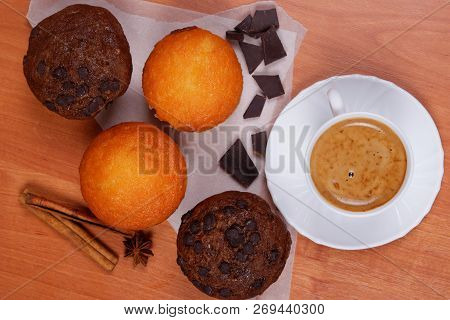 White Porcelain Cup Of Coffee, Tasty Chololate And Cinnamon Muffins, Cinnamon Sticks, Star Of Anise,