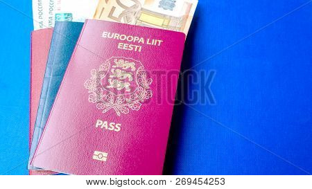 Passports On The Blue Background. Citizenship Of Estonia And Russia. Citizenship Of European Union (