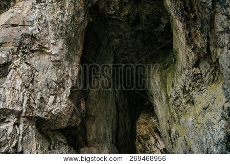 Beautiful Cave. View From Inside Dark Dungeon. Textured Walls Of Cave. Background Image Of Undergrou
