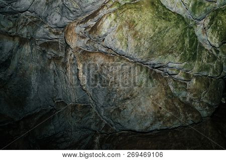 Beautiful Cave. View From Inside Dark Dungeon. Textured Walls Of Cave. Background Image Of Undergrou