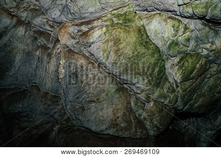 Beautiful Cave. View From Inside Dark Dungeon. Textured Walls Of Cave. Background Image Of Undergrou