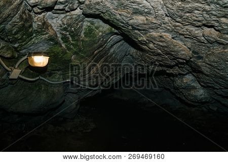 Beautiful Cave. View From Inside Dark Dungeon. Textured Walls Of Cave. Background Image Of Undergrou