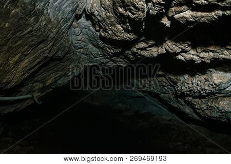 Beautiful Cave. View From Inside Dark Dungeon. Textured Walls Of Cave. Background Image Of Undergrou