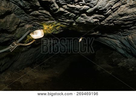 Beautiful Cave. View From Inside Dark Dungeon. Textured Walls Of Cave. Background Image Of Undergrou