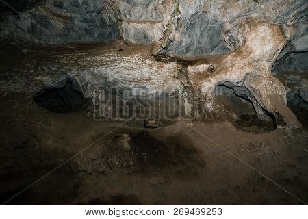 Beautiful Cave. View From Inside Dark Dungeon. Textured Walls Of Cave. Background Image Of Undergrou