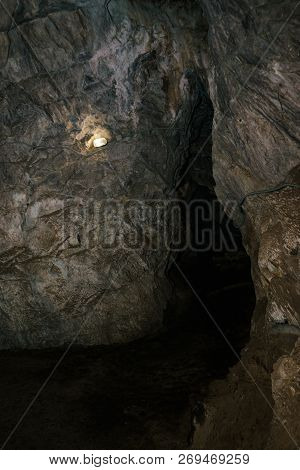 Beautiful Cave. View From Inside Dark Dungeon. Textured Walls Of Cave. Background Image Of Undergrou