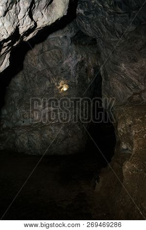 Beautiful Cave. View From Inside Dark Dungeon. Textured Walls Of Cave. Background Image Of Undergrou