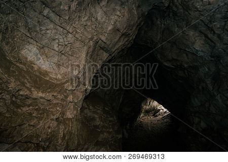 Beautiful Cave. View From Inside Dark Dungeon. Textured Walls Of Cave. Background Image Of Undergrou